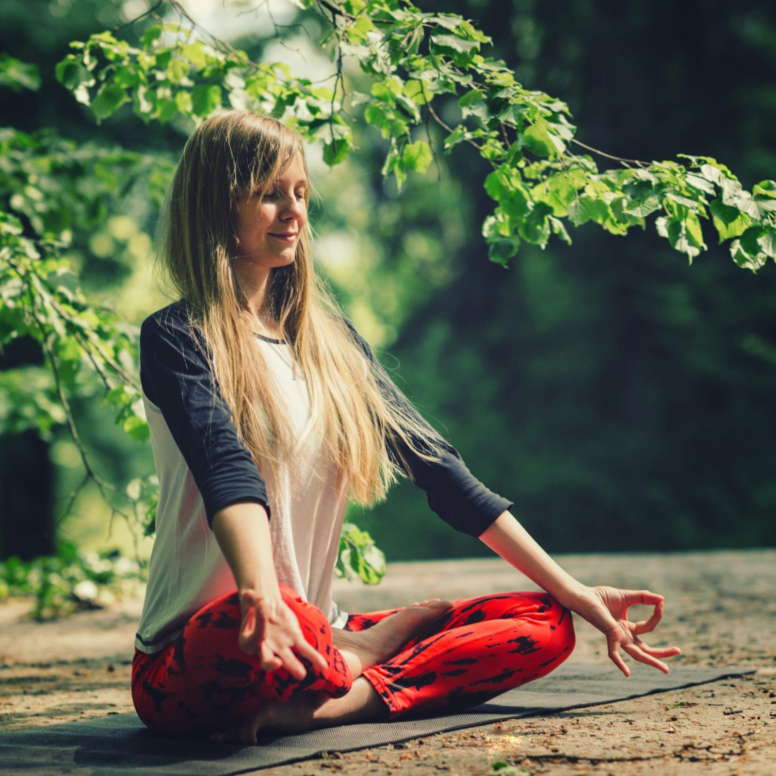 Meditation. Positive young woman meditating outdoors
